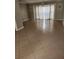 Spacious living room with tile flooring, elegant lighting, and large windows at 6906 Shady Pl, Tampa, FL 33634