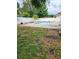 Backyard showcasing a swimming pool with a concrete deck surrounded by a white fence and lush greenery at 6906 Shady Pl, Tampa, FL 33634