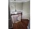 Wooden staircase with railing, connecting to the upper level of the residence at 6906 Shady Pl, Tampa, FL 33634