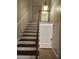 Staircase with wooden steps and white risers, leading to the upper level of the home at 6906 Shady Pl, Tampa, FL 33634