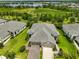 Stunning aerial view of the home showcasing its well-manicured landscaping and proximity to a tranquil lake at 7406 Parkshore Dr, Apollo Beach, FL 33572