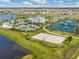 An aerial view of community amenities including pools, tennis and volleyball courts, and a lake at 7406 Parkshore Dr, Apollo Beach, FL 33572