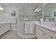 Bright bathroom featuring a glass-enclosed shower, double sinks, and white cabinetry at 7406 Parkshore Dr, Apollo Beach, FL 33572