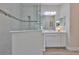 Clean and bright bathroom with a glass-enclosed shower and white vanity with ample storage at 7406 Parkshore Dr, Apollo Beach, FL 33572