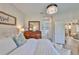 A beautifully decorated bedroom features a chandelier, a large bed, and a wooden dresser with a mirror at 7406 Parkshore Dr, Apollo Beach, FL 33572
