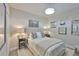 Cozy bedroom featuring neutral decor, a comfortable bed, and decorative wall art and lighting at 7406 Parkshore Dr, Apollo Beach, FL 33572