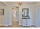 Elegant entryway featuring hardwood floors, decorative dresser, and a stylish chandelier, creating a welcoming ambiance at 7406 Parkshore Dr, Apollo Beach, FL 33572