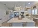Bright kitchen featuring a large center island, stainless steel appliances, and modern lighting fixtures at 7406 Parkshore Dr, Apollo Beach, FL 33572