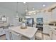 Modern kitchen with stainless steel appliances, quartz countertops, and a large center island with seating at 7406 Parkshore Dr, Apollo Beach, FL 33572