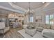 Open-concept living room featuring a kitchen with stainless steel appliances and a large, comfortable sectional sofa at 7406 Parkshore Dr, Apollo Beach, FL 33572