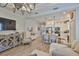 Bright living room with a view into the modern kitchen, featuring stainless appliances and a quartz countertop island at 7406 Parkshore Dr, Apollo Beach, FL 33572