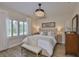 Bright and airy main bedroom with plantation shutters, stylish furniture, and a comfortable bed at 7406 Parkshore Dr, Apollo Beach, FL 33572