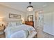 Comfortable main bedroom features a decorative wood accent, stylish furnishings, and ample natural light at 7406 Parkshore Dr, Apollo Beach, FL 33572