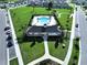 Community clubhouse and pool are surrounded by lush green spaces, palm trees, and sidewalks for residents at 7554 Wallflower Trl, Wesley Chapel, FL 33545