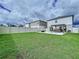 Spacious backyard featuring a concrete patio with a pergola, outdoor seating, and a fire pit at 7554 Wallflower Trl, Wesley Chapel, FL 33545