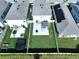 Aerial view of a well-maintained backyard featuring a patio, pergola, trampoline, and green lawn at 7554 Wallflower Trl, Wesley Chapel, FL 33545