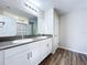 Bathroom featuring double sink vanity with modern fixtures and a large mirror at 7554 Wallflower Trl, Wesley Chapel, FL 33545