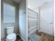 Well-lit bathroom showcases wood-look flooring, toilet, and window at 7554 Wallflower Trl, Wesley Chapel, FL 33545