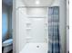 Bright bathroom with a shower and tiled surround, offering a clean and modern design at 7554 Wallflower Trl, Wesley Chapel, FL 33545