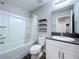 Well-lit bathroom featuring a tub, shower, modern vanity, and sleek fixtures at 7554 Wallflower Trl, Wesley Chapel, FL 33545
