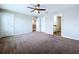 Carpeted bedroom with multiple doorways leading to closet and bathroom at 7554 Wallflower Trl, Wesley Chapel, FL 33545