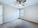 Cozy bedroom featuring neutral walls, carpet, and a ceiling fan for a comfortable atmosphere at 7554 Wallflower Trl, Wesley Chapel, FL 33545