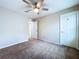 Neutral bedroom featuring carpet, a ceiling fan, and a closet for ample storage at 7554 Wallflower Trl, Wesley Chapel, FL 33545