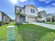 Beautiful two-story home with a well-manicured lawn and a charming light blue front door at 7554 Wallflower Trl, Wesley Chapel, FL 33545