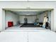 Spacious garage with high ceilings, offering ample room for parking and storage at 7554 Wallflower Trl, Wesley Chapel, FL 33545