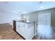 Kitchen island boasts a stainless steel dishwasher and sink, flowing into the light-filled living space at 7554 Wallflower Trl, Wesley Chapel, FL 33545