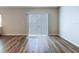 Cozy living room highlights include sliding glass doors with wood-look flooring and neutral paint at 7554 Wallflower Trl, Wesley Chapel, FL 33545