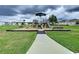 A neighborhood playground is seen on a cloudy day, featuring slides and benches at 7554 Wallflower Trl, Wesley Chapel, FL 33545
