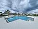 Enjoy relaxing by the beautiful community pool and cabana on a cloudy day at 7554 Wallflower Trl, Wesley Chapel, FL 33545
