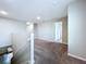 Upstairs landing features neutral carpet and walls. Several doors and railings are visible at 7554 Wallflower Trl, Wesley Chapel, FL 33545