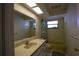 Retro bathroom features yellow tiles, a bathtub and shower combo, and vanity with ample counter space at 8209 Chaucer Dr, Weeki Wachee, FL 34607