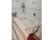 A jetted bathtub with tile surround and decorative accents above the tub creates a spa-like bathroom at 8209 Chaucer Dr, Weeki Wachee, FL 34607