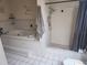 Bright bathroom featuring a jetted tub, and separate walk-in shower with tiled walls and floors at 8209 Chaucer Dr, Weeki Wachee, FL 34607