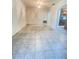 Open-concept dining room with tiled flooring and a view into the kitchen and the rest of the home at 8209 Chaucer Dr, Weeki Wachee, FL 34607