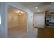 Dining room with decorative light fixture and view into the kitchen area, showcasing the tiled floors at 8209 Chaucer Dr, Weeki Wachee, FL 34607