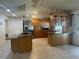 Bright kitchen features stainless steel appliances, kitchen island, and tiled floors at 8209 Chaucer Dr, Weeki Wachee, FL 34607