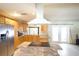 Bright kitchen with stainless steel refrigerator, granite countertops, and an island with an electric cooktop at 8209 Chaucer Dr, Weeki Wachee, FL 34607
