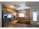 Warm kitchen with tile floors, wood cabinetry, stainless steel refrigerator and granite countertops at 8209 Chaucer Dr, Weeki Wachee, FL 34607