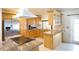 Spacious kitchen featuring wood cabinetry, stainless steel appliances, granite counters, and an island cooktop at 8209 Chaucer Dr, Weeki Wachee, FL 34607