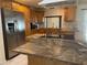 Close-up of updated kitchen featuring marble countertops and stainless steel appliances at 8209 Chaucer Dr, Weeki Wachee, FL 34607