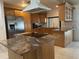 Bright kitchen with granite countertops, stainless steel appliances, and an island with an electric cooktop at 8209 Chaucer Dr, Weeki Wachee, FL 34607