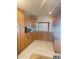 Well-lit kitchen with wooden cabinets, tile floors, and granite countertops creating an inviting culinary space at 8209 Chaucer Dr, Weeki Wachee, FL 34607