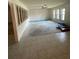 Open living room with tile and carpet flooring, large windows, and a ceiling fan at 8209 Chaucer Dr, Weeki Wachee, FL 34607