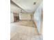 Open living room with tile and carpet flooring, a fireplace, large windows, and a ceiling fan at 8209 Chaucer Dr, Weeki Wachee, FL 34607