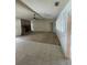 Open living room with tile and carpet flooring, a fireplace, large windows, and a ceiling fan at 8209 Chaucer Dr, Weeki Wachee, FL 34607