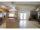 Open floorplan displaying the kitchen with an island cooktop and a cozy living room with a fireplace at 8209 Chaucer Dr, Weeki Wachee, FL 34607
